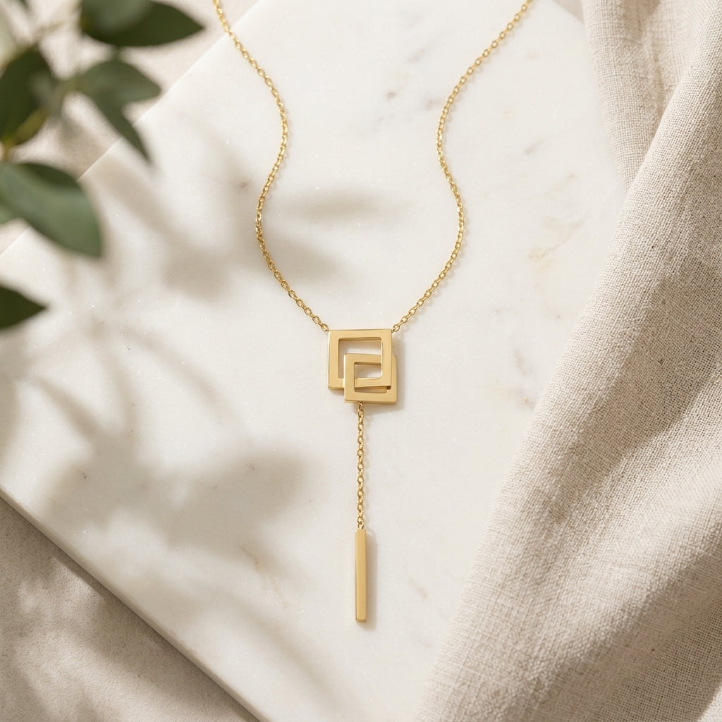 Élan Geometric Drop Necklace in Gold Finish | Minimal Luxury Statement Pendant by VarnamAyira
