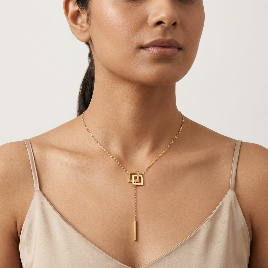 Élan Geometric Drop Necklace in Gold Finish | Minimal Luxury Statement Pendant by VarnamAyira